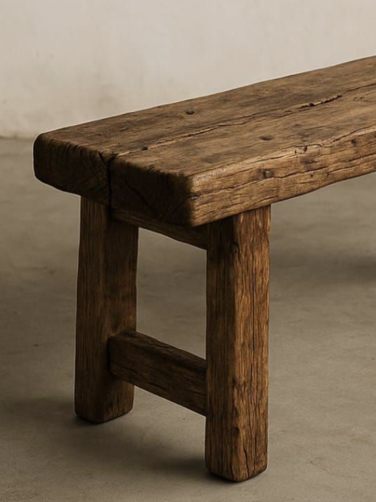 Ein rustikale Holztbank mit stabilen Beinen und natürlichem, unbehandeltem Finish.